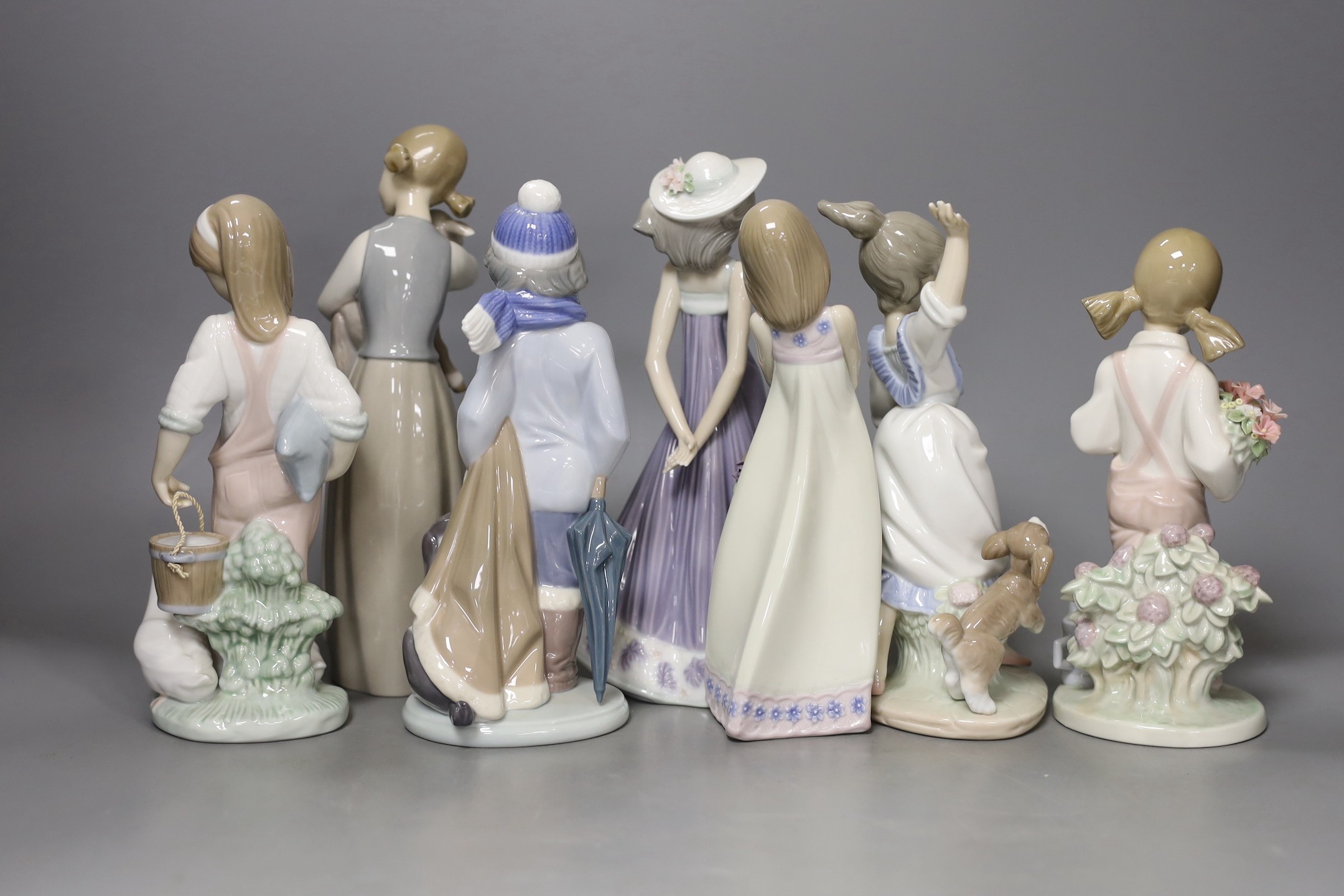 A collection of seven Lladro figures, tallest 22 cm, to include a girl with lamb, a girl with duck and duckling, etc.